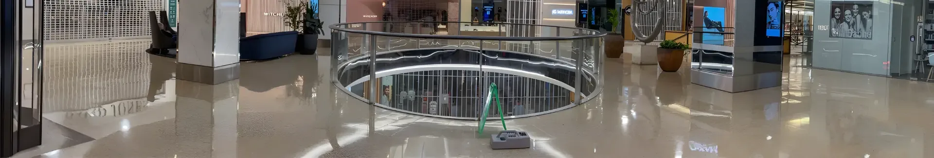 Panoramic shopping centre atrium with reflective hard flooring being assessed for slip resistance