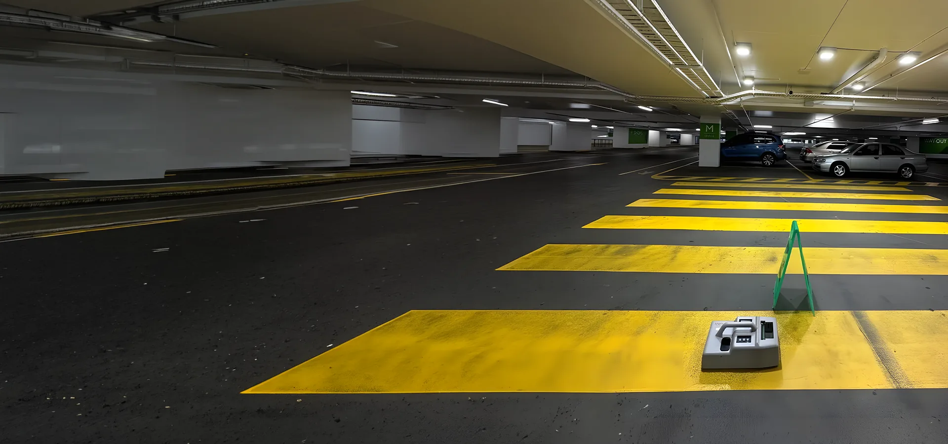 Floor friction tester on a yellow pedestrian crossing in an undercover car park