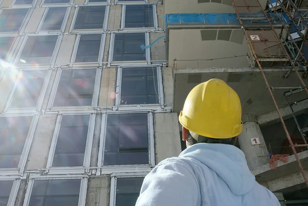 Worker on a new commercial building site before handover